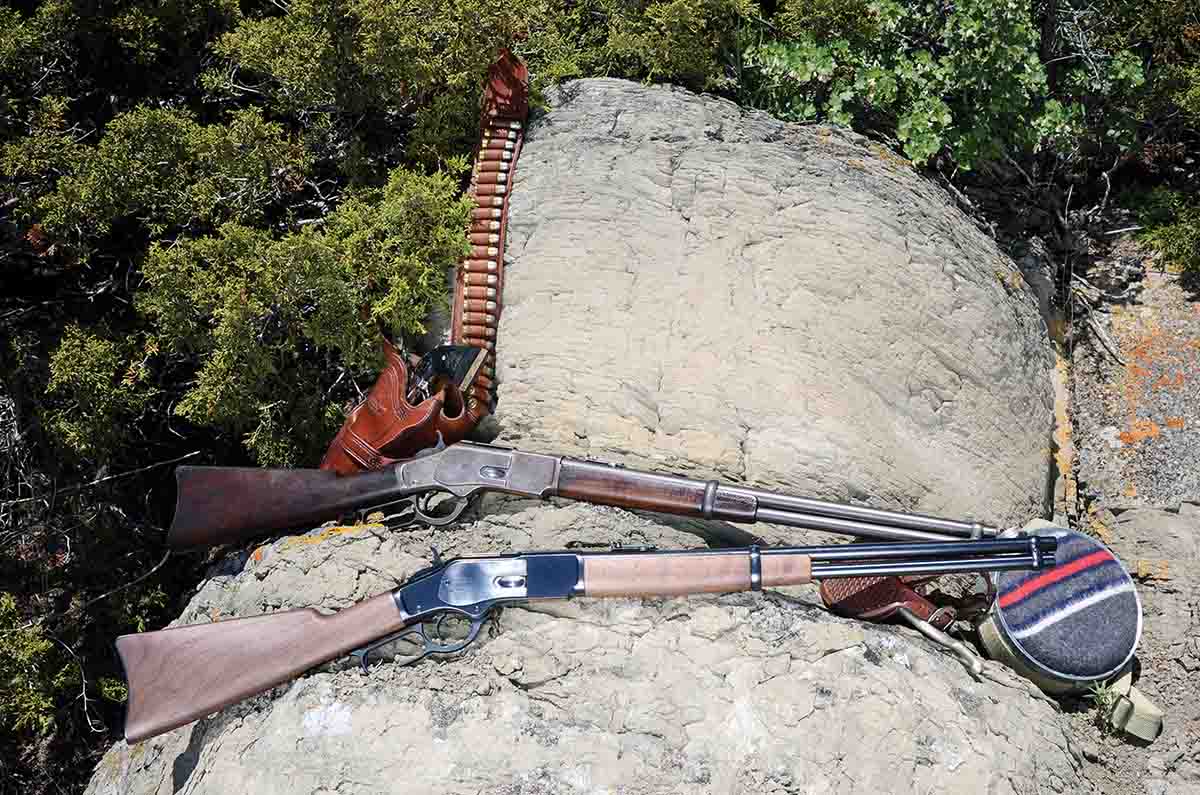 An original 1899 vintage Winchester saddle ring carbine (top) is shown with a new Miroku/Winchester saddle ring carbine.